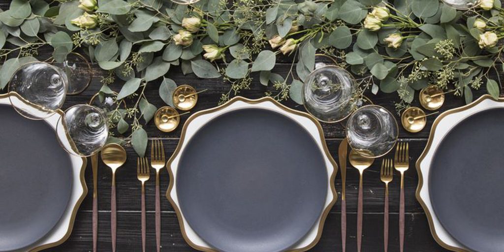 Image of modern tablescape with table settings and greenery