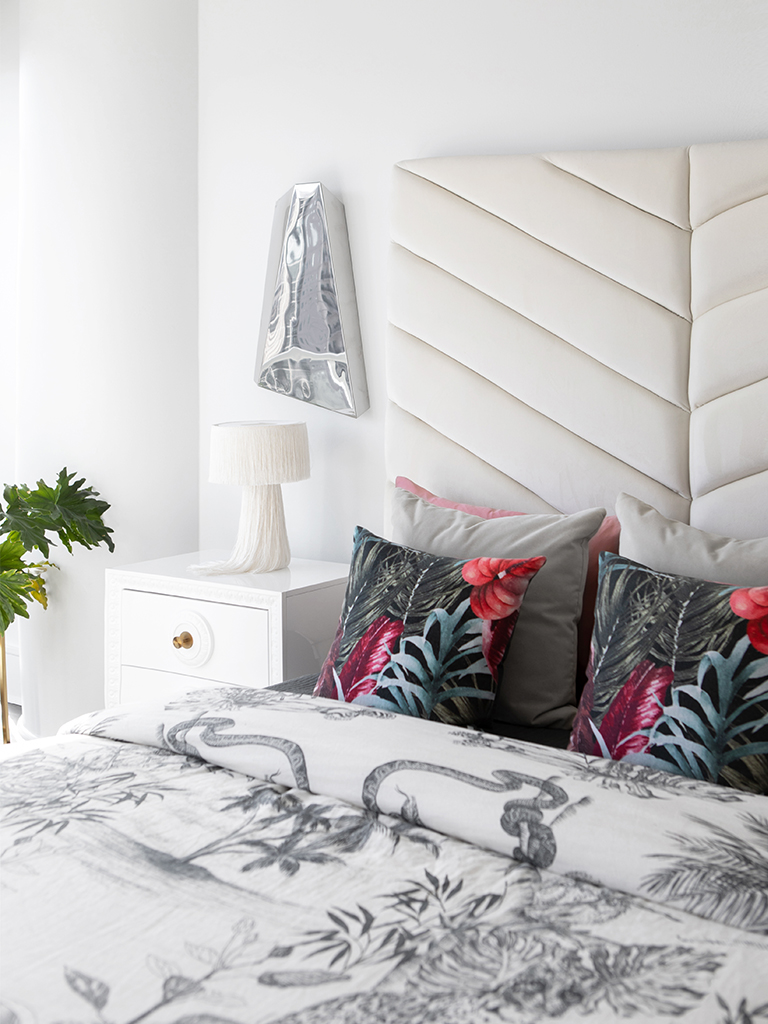Modern designed bedroom with patterned bedding and modern accessories.
