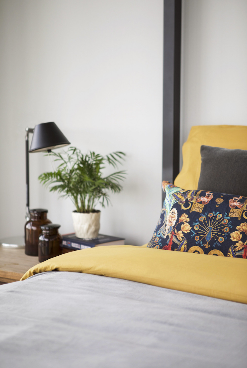 dallas-tx-accent-pillows-yellow-comforter-bedroom-design