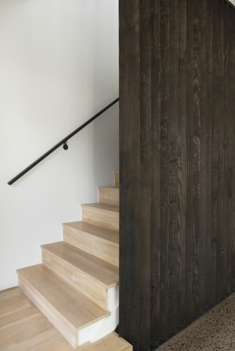 dark-wood-partition-wall-light-wood-staircase