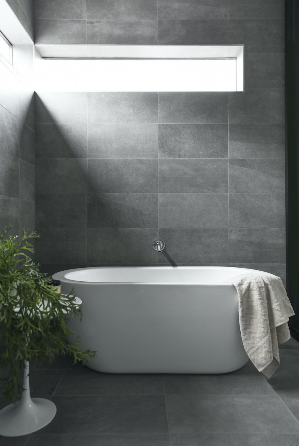 freestanding-bathrub-gray-tile-natural-light