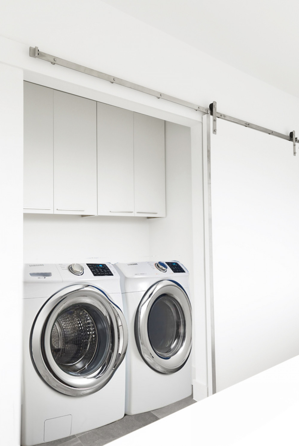 sliding-laundry-room-door-hidden-storage-washer-dryer