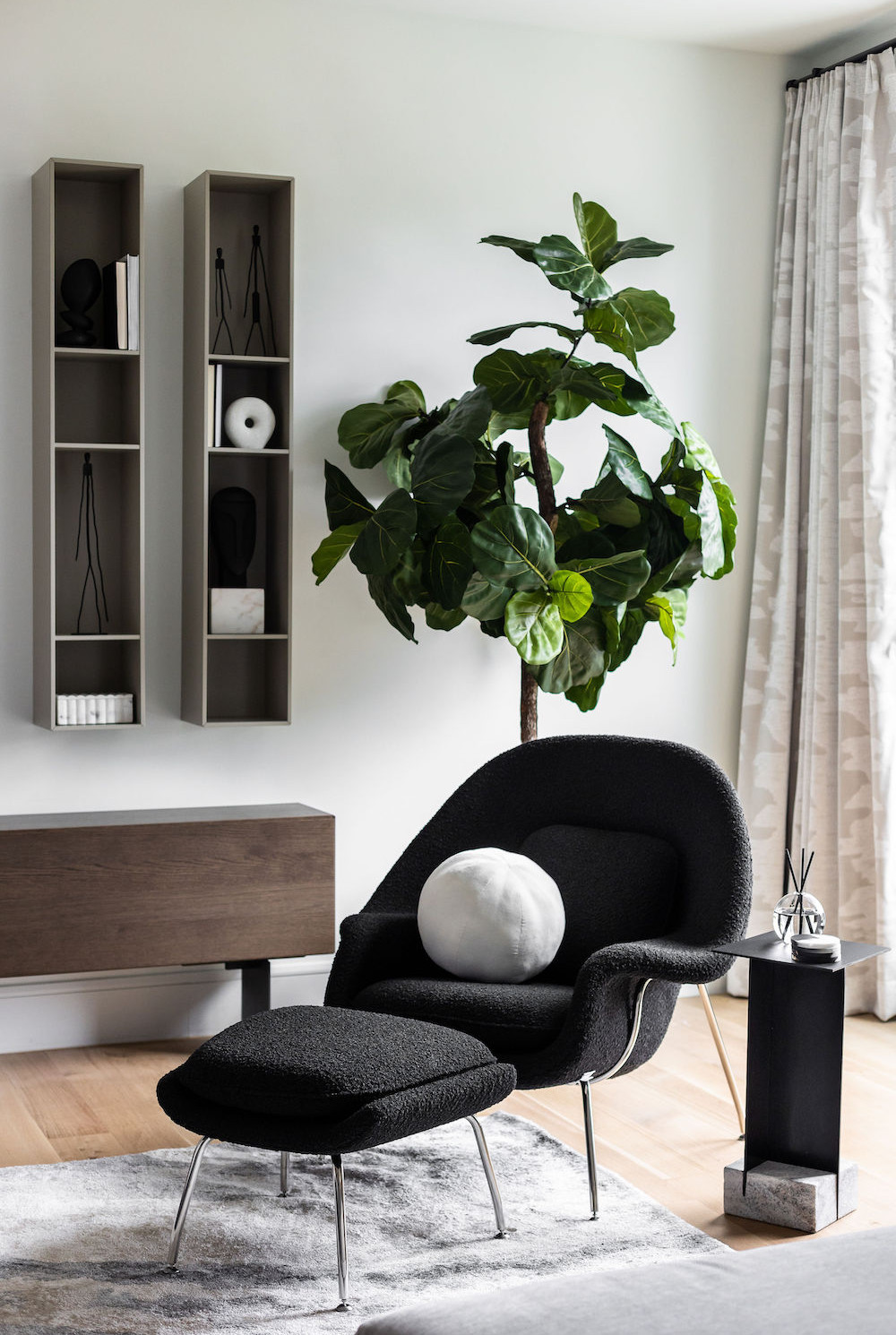 beyond-interior-design-black-accent-chair-white-sphere-pillow
